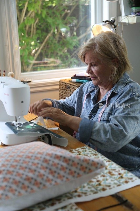 70 years old doing sewing in her home